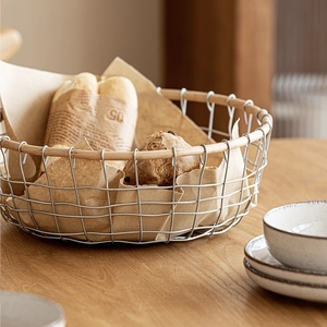 Modern wire fruit basket with wooden rim and round metal grid for kitchen storage