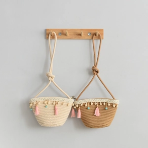 Handmade woven mini straw bags for kids in cream and khaki with cute tassel details