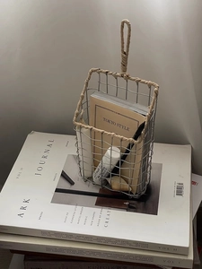 Detail of Nordic iron wire wall basket with paper rope handle for magazine storage
