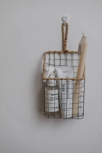 Detail of silver wire wall basket with natural hemp rope handle and mesh grid structure
