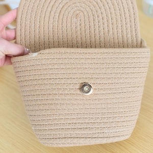 Detail of khaki cotton rope woven bag featuring a secure metal magnetic clasp closure