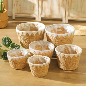 Detail of woven straw plant baskets showing waterproof inner lining and Nordic texture