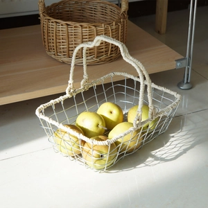Handcrafted iron storage basket with cotton rope handles and fresh pears inside