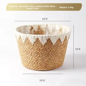 Detail view of woven grass planter with white fringe decor and plastic waterproof lining