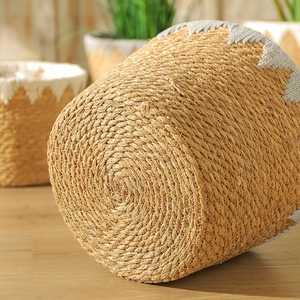 Nordic hand-woven seagrass planter basket with decorative white zigzag stitching
