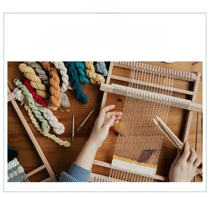 Macro detail of wooden weaving loom set with colorful yarn and shuttle on wood table