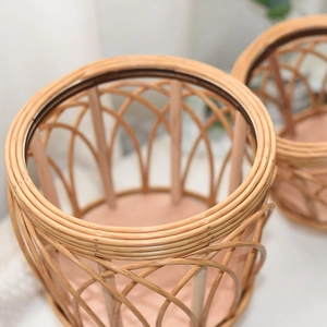 Close-up detail of hand-woven rattan planter featuring solid wood support and arch-grid weave