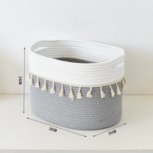 Detail view of woven cotton rope storage basket with tassels, size 38x26x24 cm