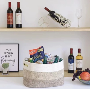 Close-up of a three-color woven cotton rope storage basket with dual handles and drinks inside