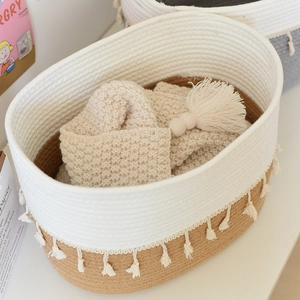 Detail of cotton rope storage basket featuring bicolor weaving and stylish tassel trim