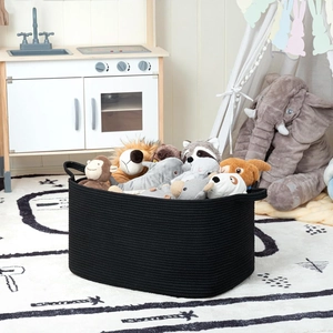 Close-up of rectangular black woven cotton rope basket filled with plush toys for storage