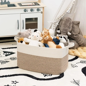 Detail of a large woven cotton rope storage basket filled with plush toys in a nursery