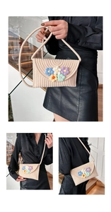 Detailed macro view of beige woven crossbody bag with colorful handmade crochet flowers