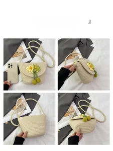 Detailed views of beige woven mini bag with yellow floral charms and long tassels