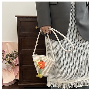 Detail of hand-woven crossbody bag featuring crochet flowers and colorful stripes