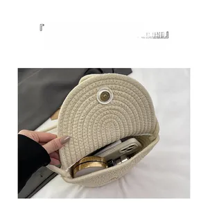 Detailed top view of a woven straw shoulder bag showing interior space for phone and makeup