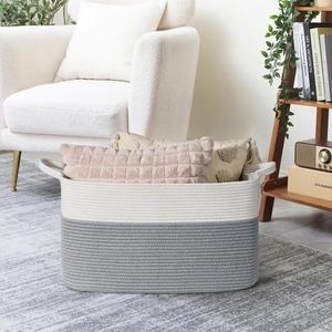 Detail showing handwoven cotton rope basket storing soft pillows in cozy home setting