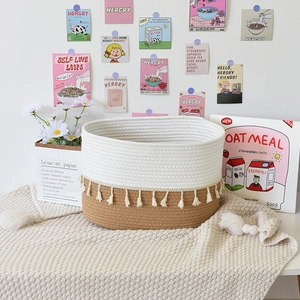 Detailed texture of cotton rope storage basket featuring white and brown tones with tassels