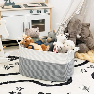 Close-up of a large cotton rope basket storing plush toys in a cozy nursery room