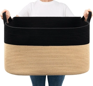 Detail view of large cotton rope woven storage basket with dual handles and two-tone design