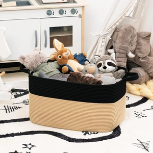 Detail of woven cotton rope storage basket with dual-tone black design and handles