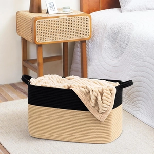 Close-up of dual-tone woven cotton rope basket storage with durable carry handles