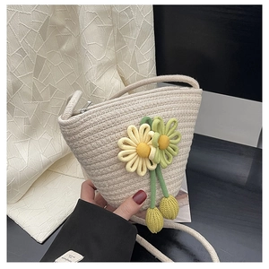 Detail of hand-woven beige mini crossbody bag with yellow sunflower floral accents
