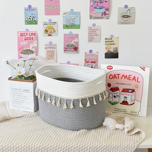 Gray and cream cotton rope woven storage basket with tassels for home organization