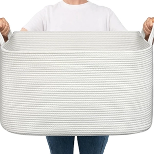Large woven cotton rope storage basket with dual handles shown in a handheld view