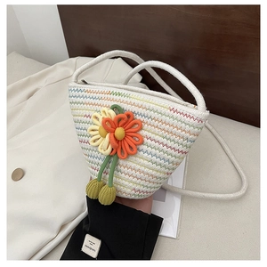 Close-up of woven bag with colorful zigzag stitching and crochet flower details