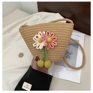 Detailed macro of a handmade woven straw bag featuring 3D floral accents and strap