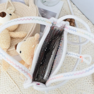 Detail view of woven cotton bag interior showing spacious storage for a smartphone