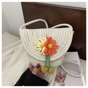 Close-up of handmade woven flower bag with detailed colorful wavy stitching and 3D floral accent