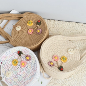 Three handmade woven straw crossbody bags with 3D flowers, leaves and ladybug details