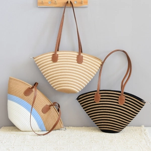 Detail of woven beach tote bags with leather handles and zip closure in three colors
