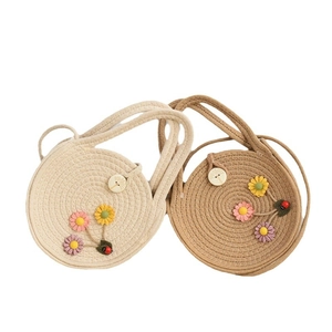 Handmade woven straw round crossbody bags in beige and brown with floral and ladybug decor