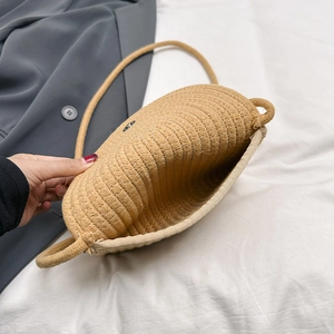 Woven straw crossbody bag for women featuring a magnetic snap closure and thick braided strap