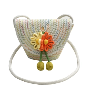 Close-up of woven flower bag with sunflower decoration and green crochet charms