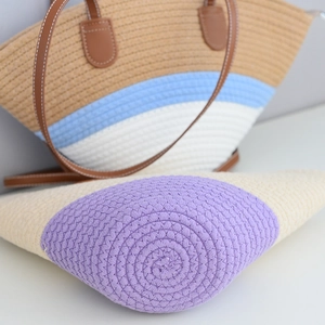 Detailed view of handmade woven cotton shoulder bag with durable leather handles