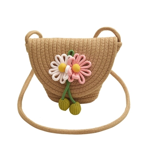 Detailed macro view of handcrafted woven bag with 3D floral embellishments and strap