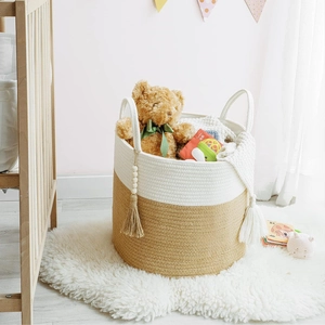 Detailed texture of woven cotton rope storage basket with decorative wood bead tassel