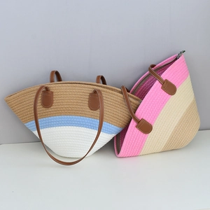 Detail of multi-color woven tote bags with leather handles and top zipper closure