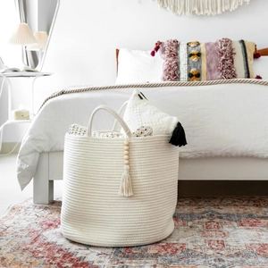 Creamy white cotton rope woven storage basket with tassels for home laundry organization