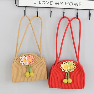 Detailed close-up of handmade woven cotton rope bags with floral accents and spiral texture