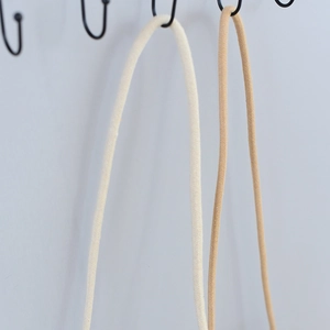 Detail of woven cylindrical straps in beige and light brown for beach bags and DIY crafts
