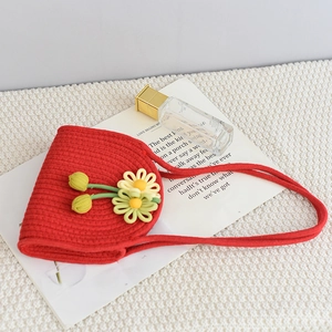 Detail of red hand-woven cotton rope mini bag with colorful floral embroidery