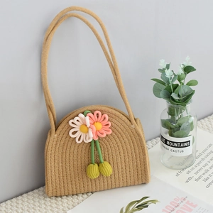 Detail of handmade cotton rope woven bag with colorful 3D knitted flower decorations