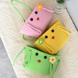 Close-up of cute cartoon 3-tier knitted hanging storage baskets with floral details