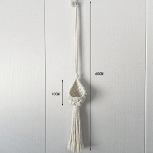 Detail of macramé hanging plant basket with dimensions and long tassel decoration