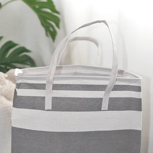 Detail of the gray and white striped canvas laundry basket with durable thick handles